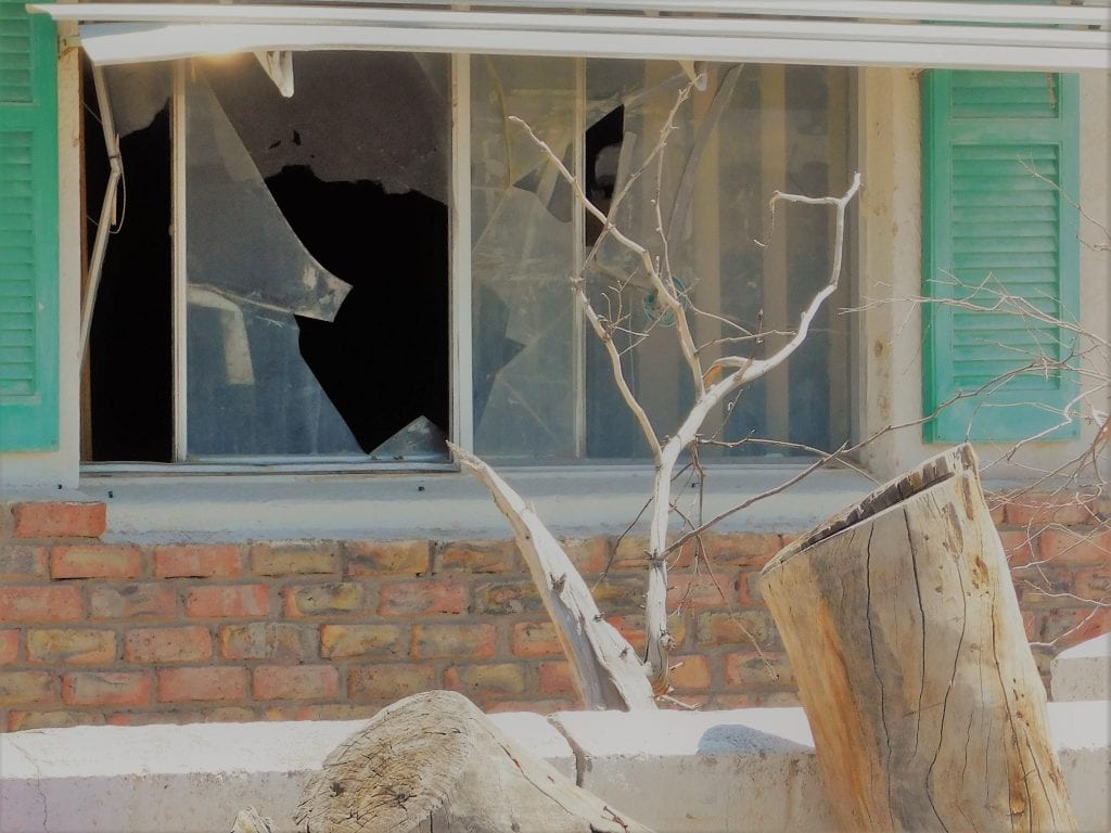 broken windows in a vandalized home