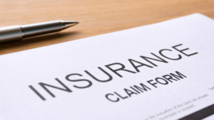 insurance claim paperwork and a pen